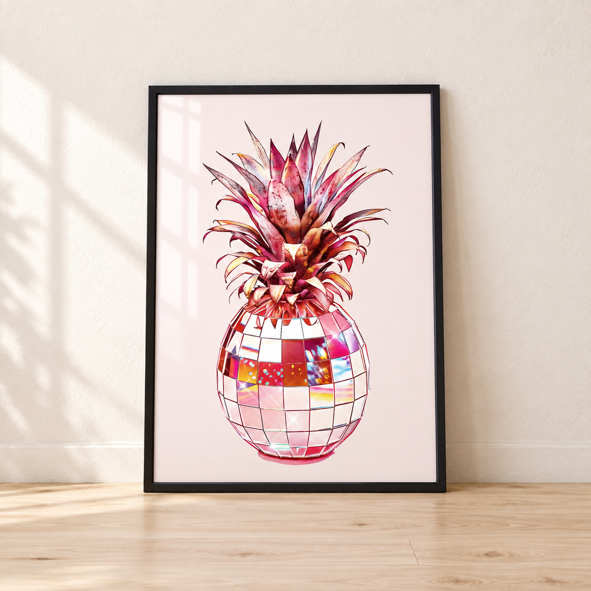 Disco Ball Pineapple print in a glossy black frame leaning against a wall