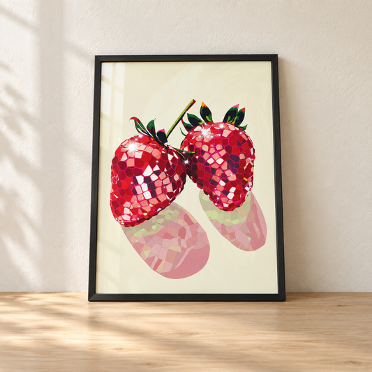 Disco Ball Strawberries print in a glossy black frame leaning against a wall