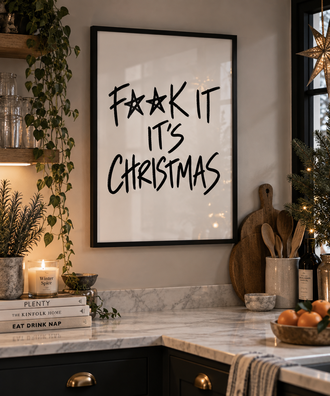 F**k It It's Christmas print in a black frame in a festive kitchen