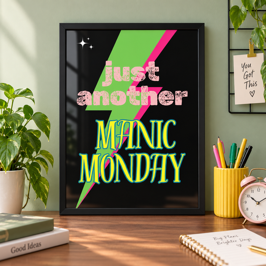 Manic Monday music print in a black frame on a home office desk