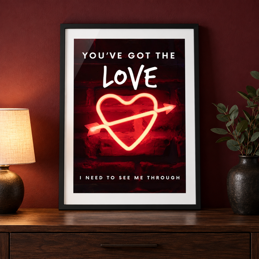 You've Got the Love music print in a black frame on a walnut console